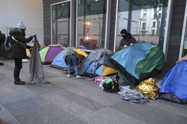 Police clear out a migrant camp in central Paris. Activists say it's a pre-Olympics sweep